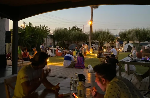 Akşam bahçede oturan kamp misafirleri